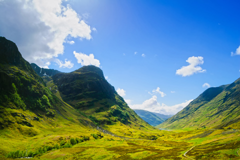 The Three Sisters of Glen Coe mountain range seen on a summer day with blue skies