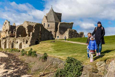 Family exploring Inchcolm Abbey