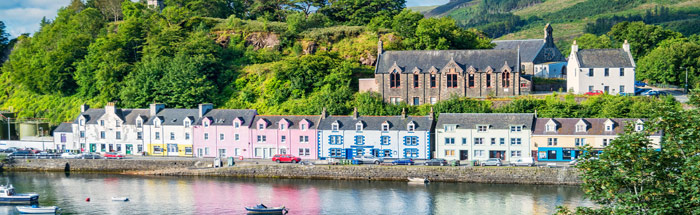 Pastel painted buildings surround Portree Harbour, Isle of Skye