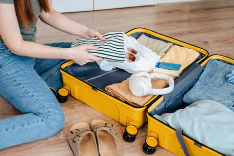 A girl packing her suitcase