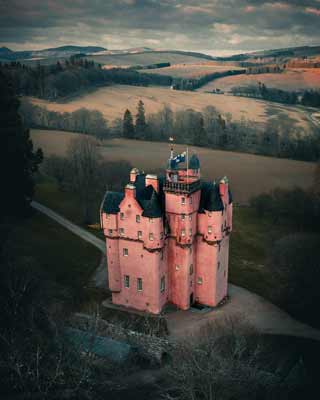 The pink walls of Craigvievar Castle viewed from above