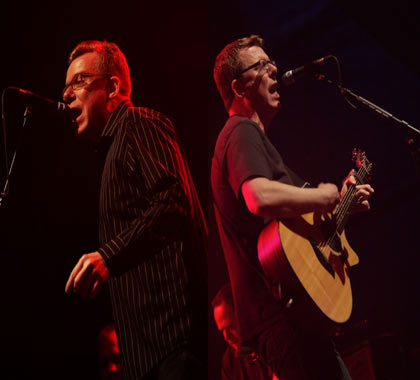 The Proclaimers Craig and Charlie Reid back to back on stage performing