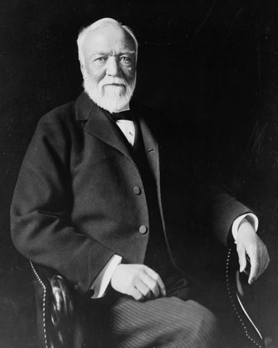 Black and white photogrph of Andrew Carnegie, seated with partly bald head and white beard