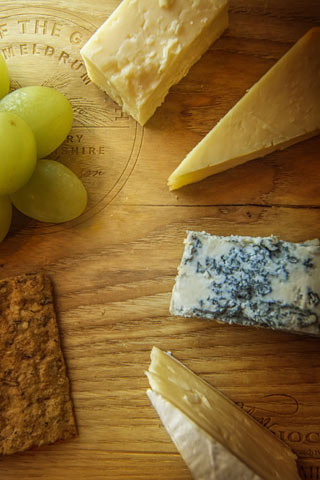 a selection of 4 cheeses with oatcake and grapes