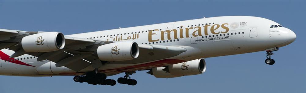 Emirates plane in flight with blue sky