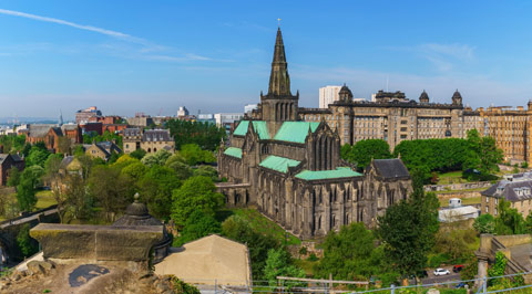  Glasgow Cathedral with steeple and lovely mature green patina on the roofs on a bright day 