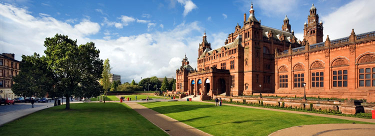 Kelvingrove Art Gallery and Museum - red sandstone building surrounded by lawns