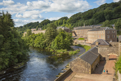 mill and millworkers cottages alongside the river at New Lanark