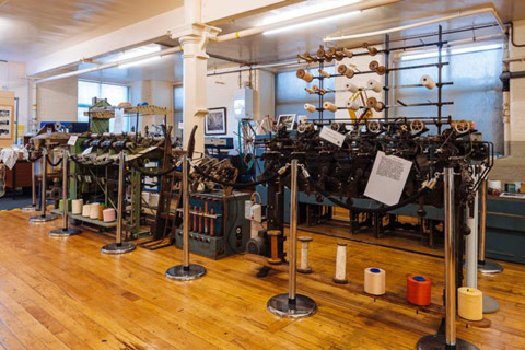 interior of Paisley Thread Mill Museum showing looms and yarn