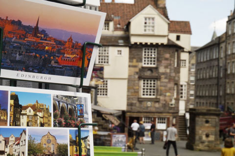 Postcards for sale in a stand outside John Knox House in Edinburgh