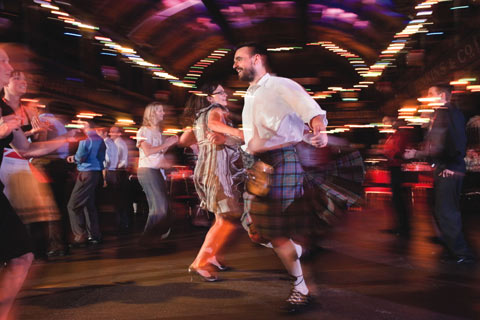 Slightly blurred image of man and woman spinning around in dance at a ceilidh