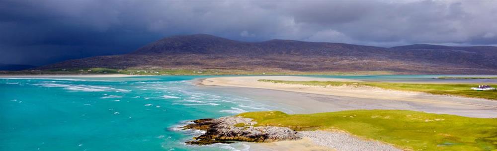 Bright turquoise sea and white beach with Machair 