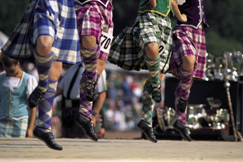 Four Scottish country dancers competing in Highland Games