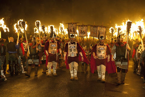 Vikings march in a torch-light parade to celebrate Up Helly AA 